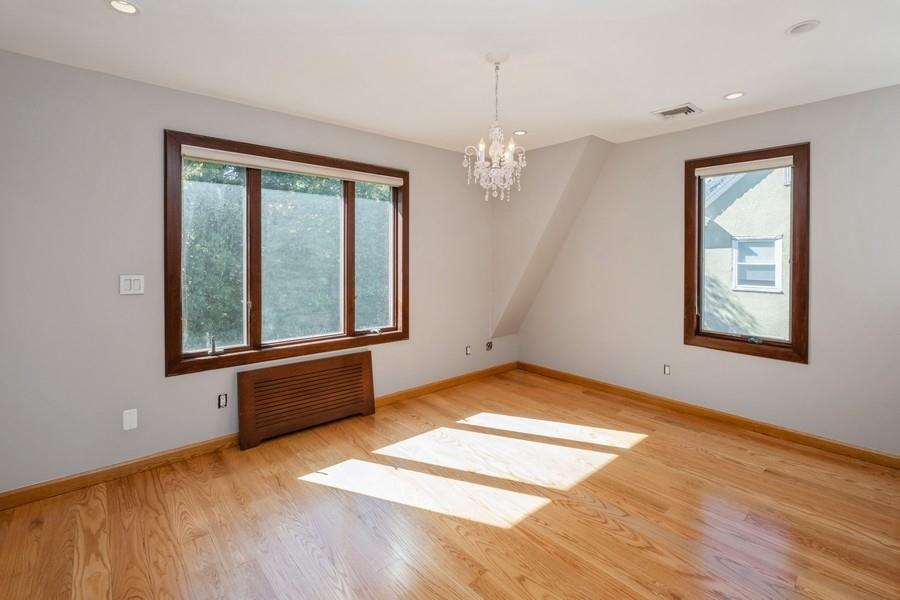 211 81st Street Brooklyn, NY 11209 - Photo 21 of 35 a view of an empty room with wooden floor and a window