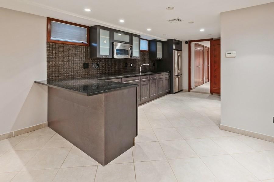 211 81st Street Brooklyn, NY 11209 - Photo 27 of 35 a kitchen with stainless steel appliances granite countertop a sink and a refrigerator