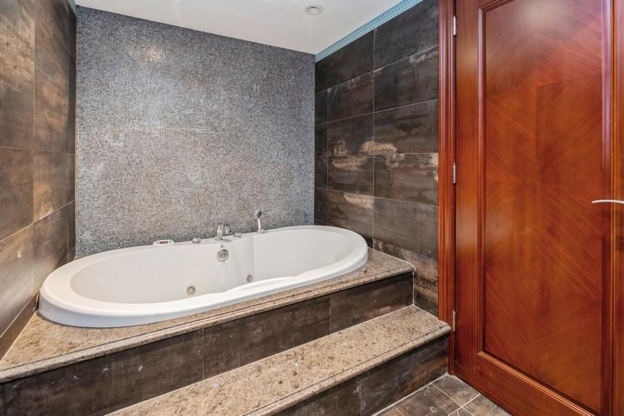 211 81st Street Brooklyn, NY 11209 - Photo 30 of 35 a bathroom with a tub and shower