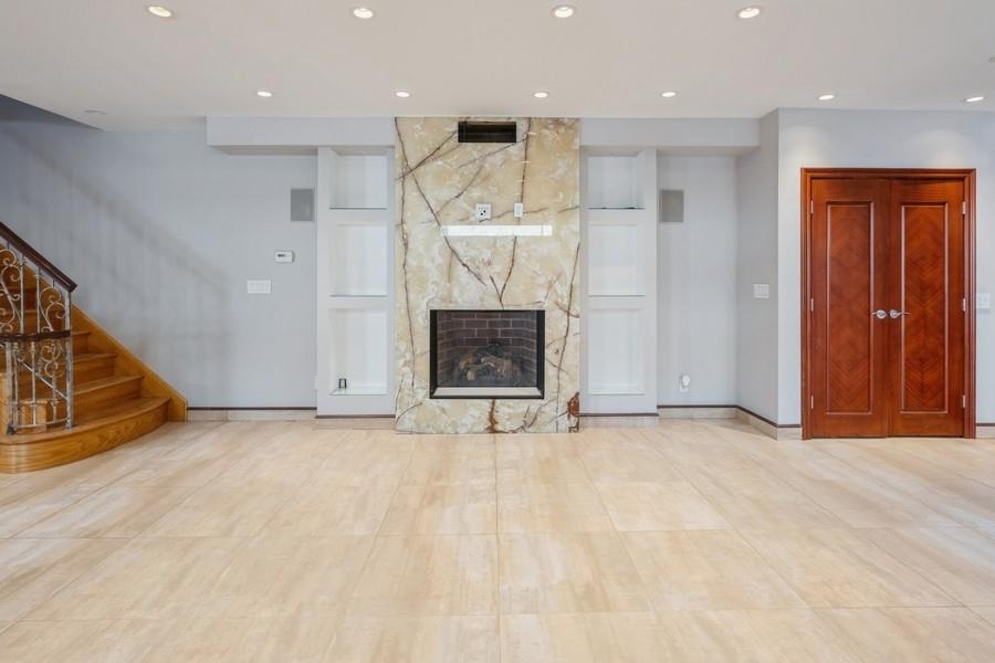 211 81st Street Brooklyn, NY 11209 - Photo 7 of 35 an empty room with wooden floor fireplace and windows