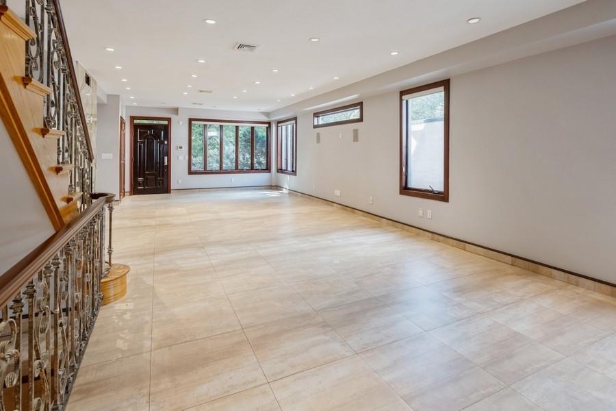 211 81st Street Brooklyn, NY 11209 - Photo 9 of 35 a view of an empty room with stairs and furniture
