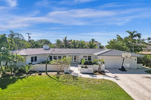 an aerial view of a house with swimming pool garden and patio