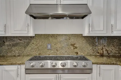 a stove top oven sitting inside of a kitchen