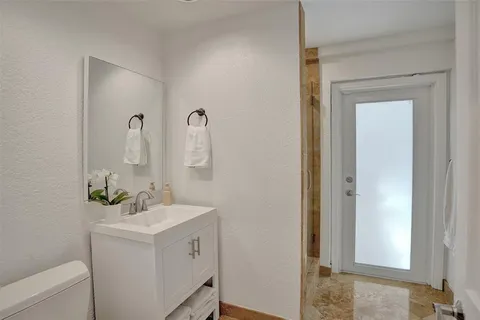 a bathroom with a sink mirror and vanity