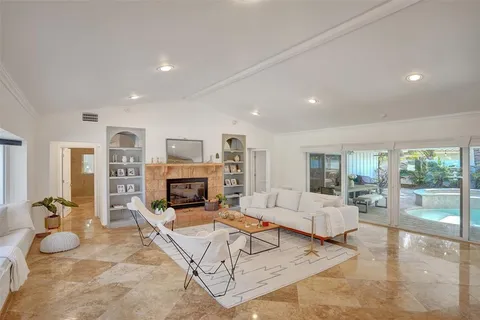 a living room with furniture large window and flat screen tv