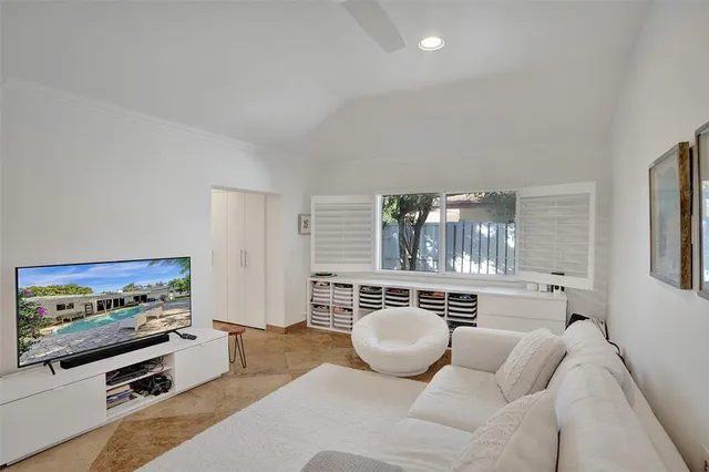 a living room with furniture a flat screen tv and gym equipment