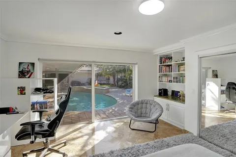 a living room with furniture and a floor to ceiling window