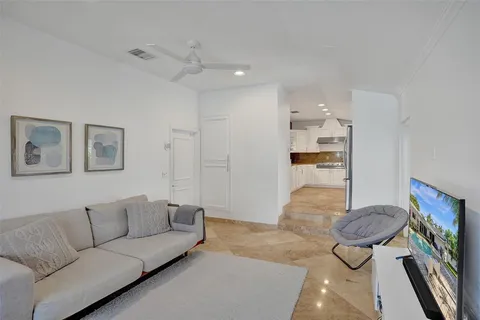 a living room with furniture potted plant and a table