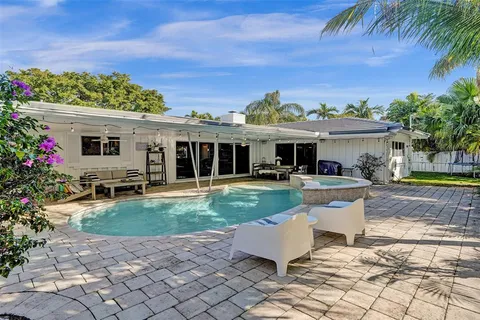 a view of a house with backyard porch and sitting area