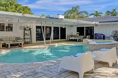 a view of a house with backyard sitting area and garden