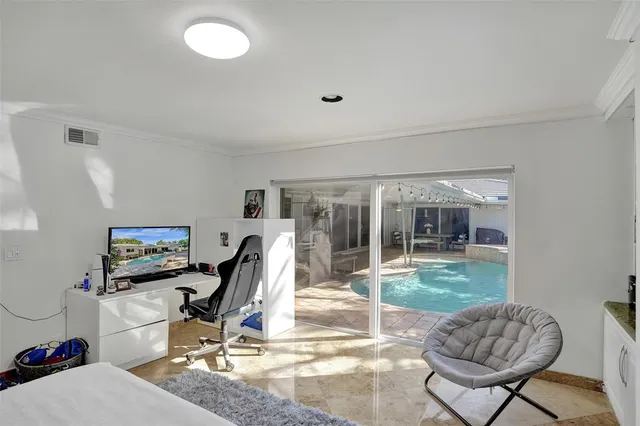 a living room with furniture and a floor to ceiling window