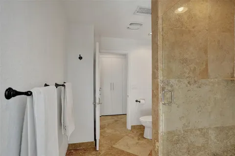 a bathroom with a granite countertop shower