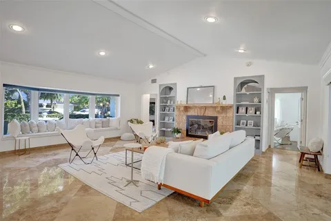 a living room with fireplace furniture and a wooden floor