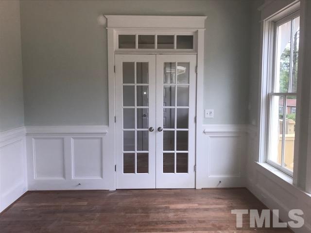1005 Norris Street Raleigh, NC 27604 - Photo 11 of 25 a view of empty room with wooden floor and windows