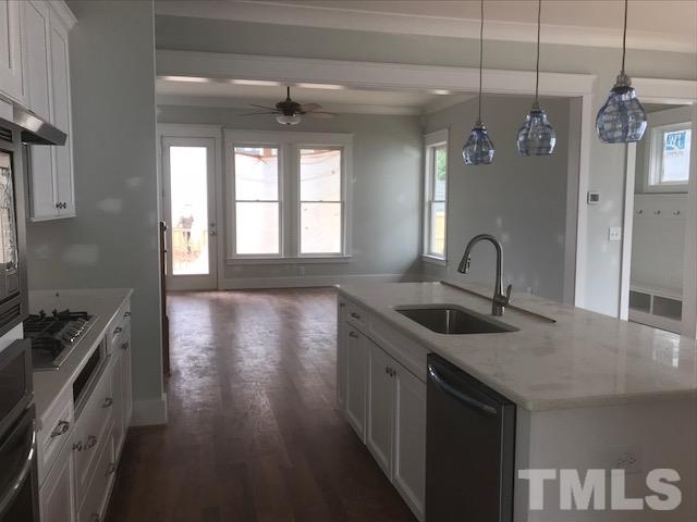 1005 Norris Street Raleigh, NC 27604 - Photo 12 of 25 a kitchen with stainless steel appliances granite countertop a sink stove and refrigerator