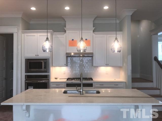 1005 Norris Street Raleigh, NC 27604 - Photo 15 of 25 a kitchen with counter top space cabinets and stainless steel appliances