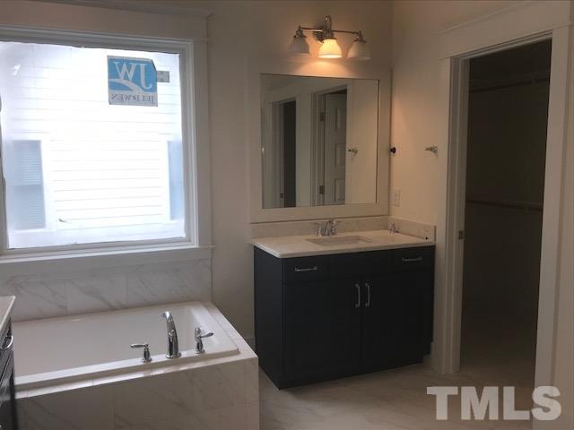 1005 Norris Street Raleigh, NC 27604 - Photo 22 of 25 a bathroom with a sink and a mirror
