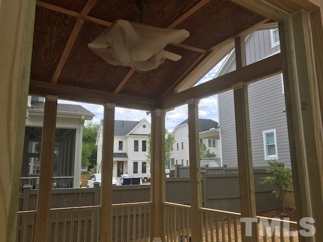 1005 Norris Street Raleigh, NC 27604 - Photo 4 of 25 a view of a porch with a table and chairs