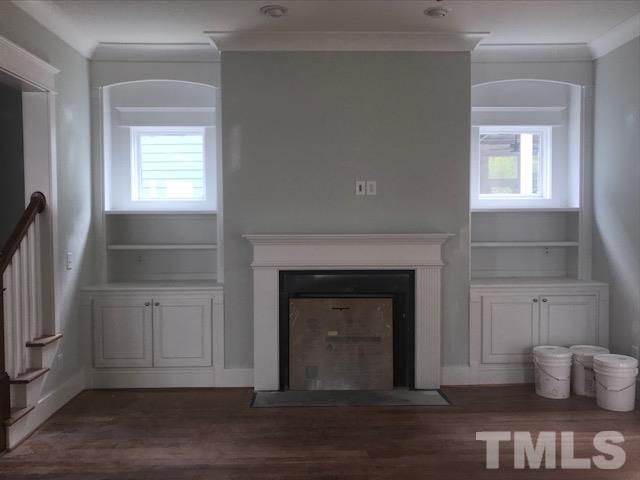 1005 Norris Street Raleigh, NC 27604 - Photo 9 of 25 a view of a livingroom with wooden floor and a fireplace
