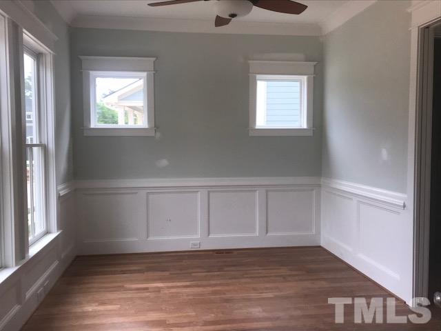 1005 Norris Street Raleigh, NC 27604 - Photo 10 of 25 a view of an empty room with wooden floor and a window