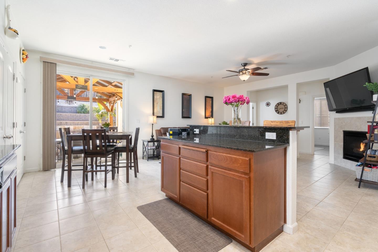 2448 Vallarta Drive Bay Point, CA 94565 - Photo 13 of 52 a kitchen with kitchen island granite countertop a table chairs microwave and sink