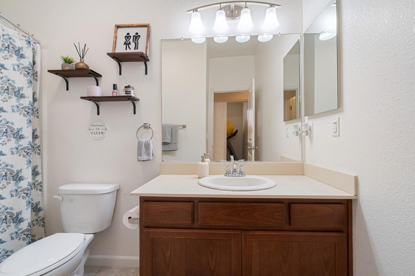 2448 Vallarta Drive Bay Point, CA 94565 - Photo 25 of 52 a bathroom with a sink a toilet and a mirror