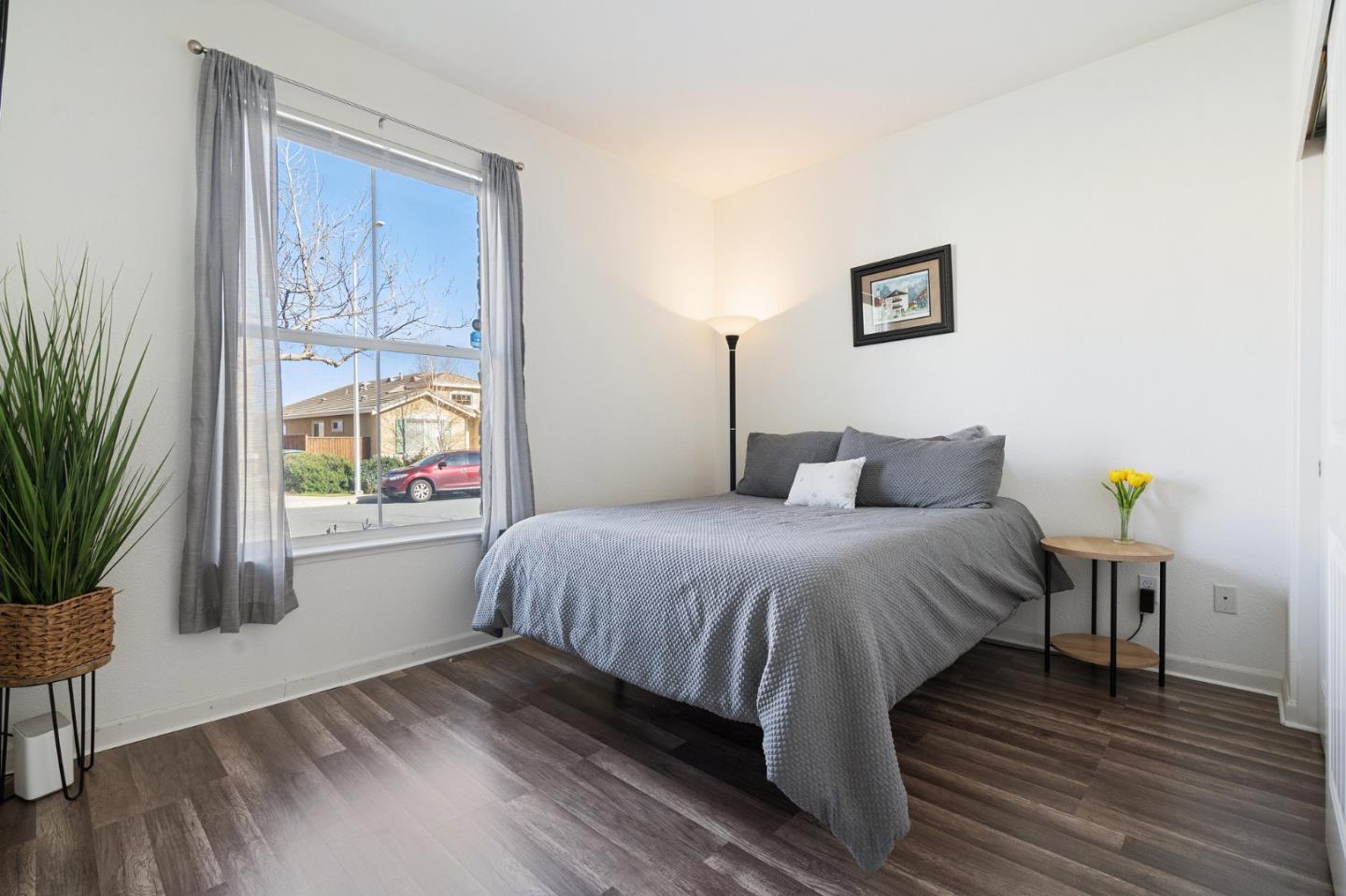2448 Vallarta Drive Bay Point, CA 94565 - Photo 29 of 52 a bedroom with a bed and a potted plant on dresser
