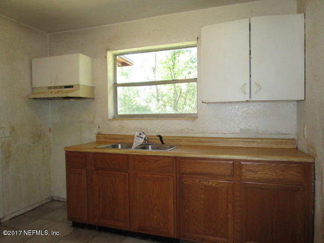 6912 Corday Road Jacksonville, FL 32208 - Photo 4 of 10 a kitchen with a sink cabinets and a window