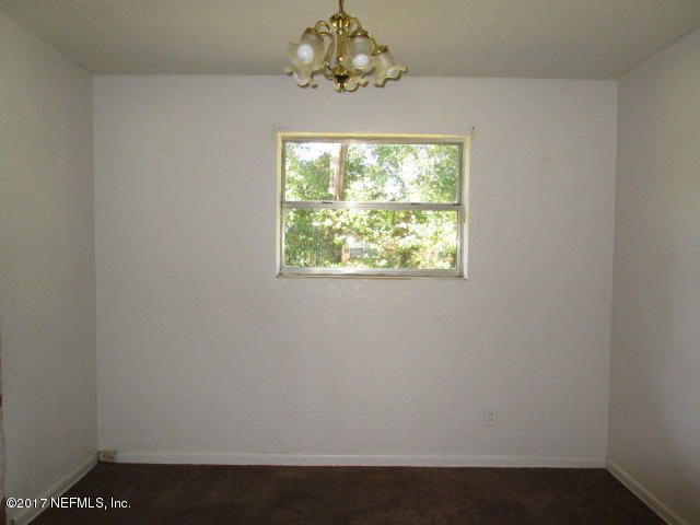 6912 Corday Road Jacksonville, FL 32208 - Photo 5 of 10 an empty room with a window