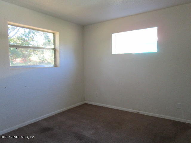 6912 Corday Road Jacksonville, FL 32208 - Photo 7 of 10 an empty room with a window