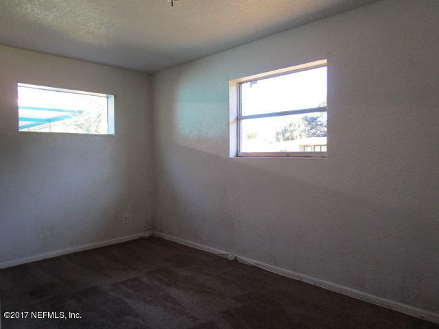 6912 Corday Road Jacksonville, FL 32208 - Photo 8 of 10 an empty room with a window
