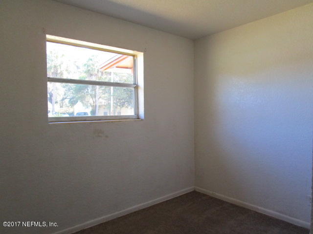6912 Corday Road Jacksonville, FL 32208 - Photo 9 of 10 an empty room with a window