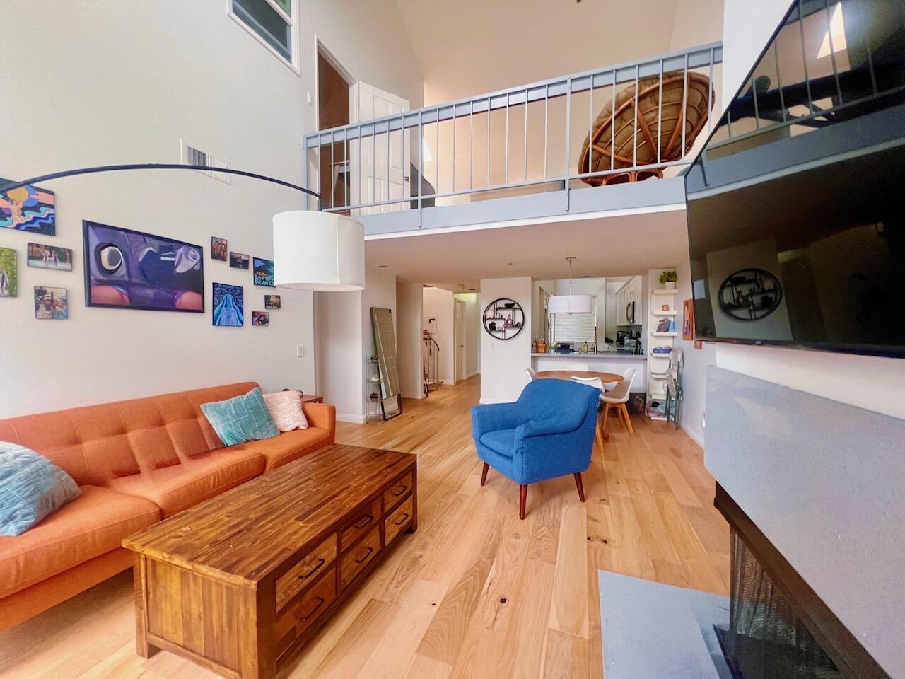 20371 Bluffside Circle, Unit B404 Huntington Beach, CA 92646 - Photo 1 of 40 a living room with furniture a rug and a chandelier
