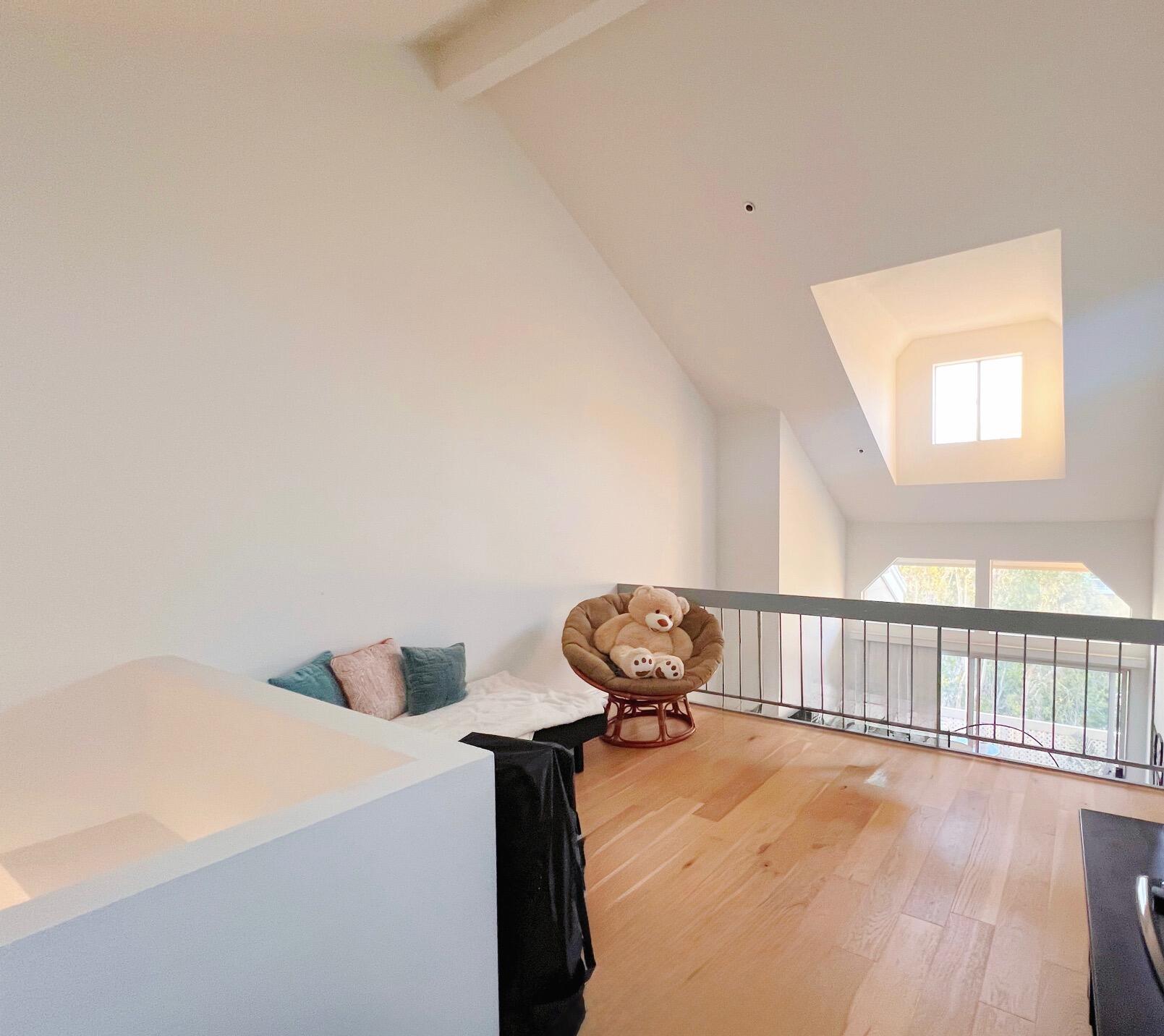 20371 Bluffside Circle, Unit B404 Huntington Beach, CA 92646 - Photo 30 of 40 a bedroom with a bed and wooden floor