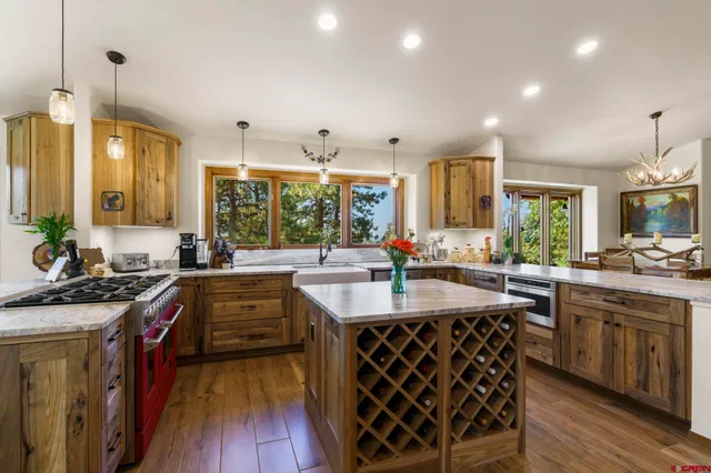 a kitchen with kitchen island granite countertop a sink stove and cabinets
