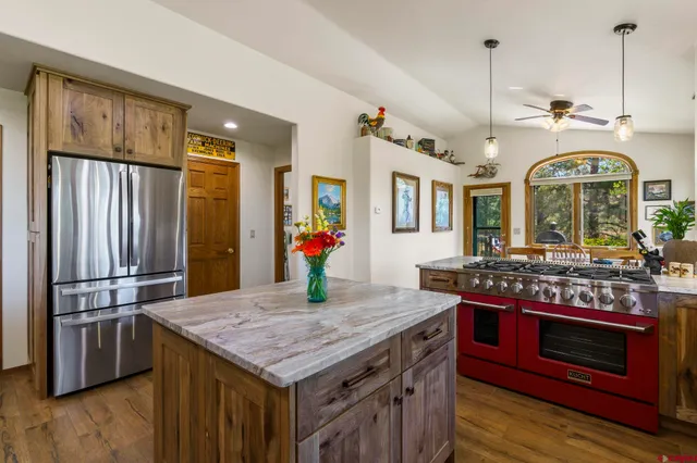 a kitchen with stainless steel appliances granite countertop a stove and a refrigerator