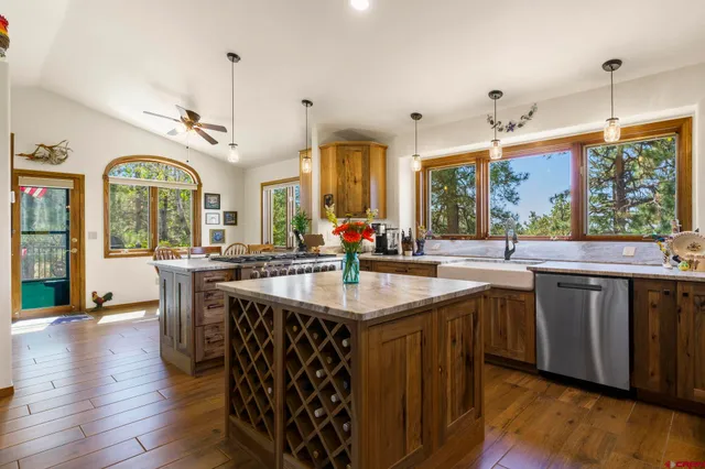 a kitchen with counter top space sink and living room view