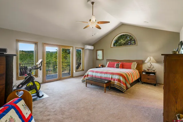 a bedroom with a bed a couch and a window