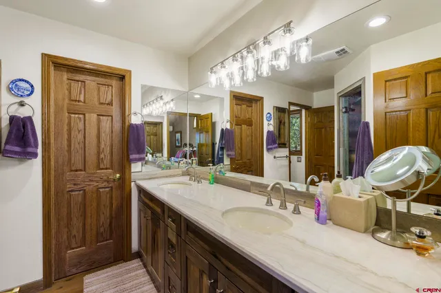 a bathroom with a sink double vanity and a mirror