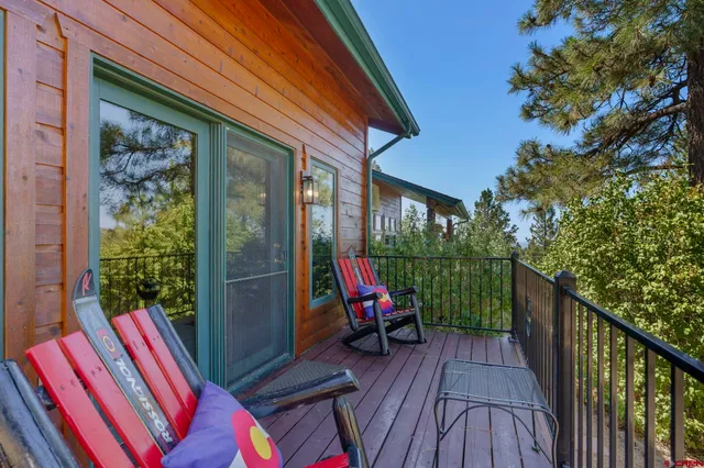 a view of deck with furniture and garden