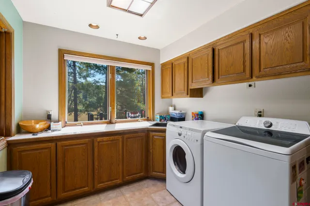 a utility room with sink dryer and washer