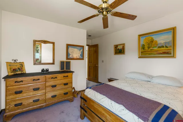 a bedroom with a bed and a dresser in it