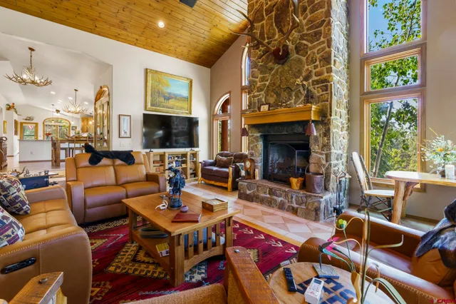 a living room with furniture fireplace and a large window