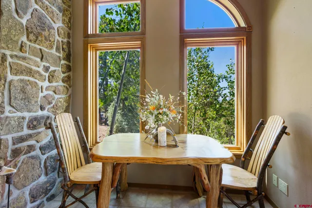 a view of a dining room with furniture and window