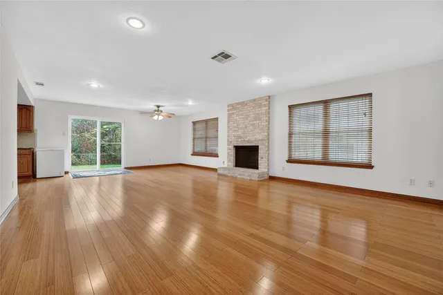a view of a livingroom with wooden floor and a ceiling fan