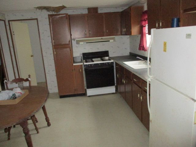 2658 Tribble Road Fort Valley, GA 31030 - Photo 3 of 6 a kitchen with a refrigerator and a stove