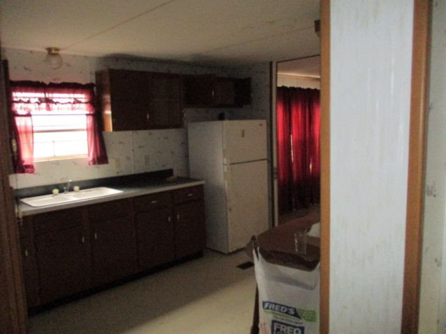 2658 Tribble Road Fort Valley, GA 31030 - Photo 6 of 6 a kitchen with a refrigerator and a sink