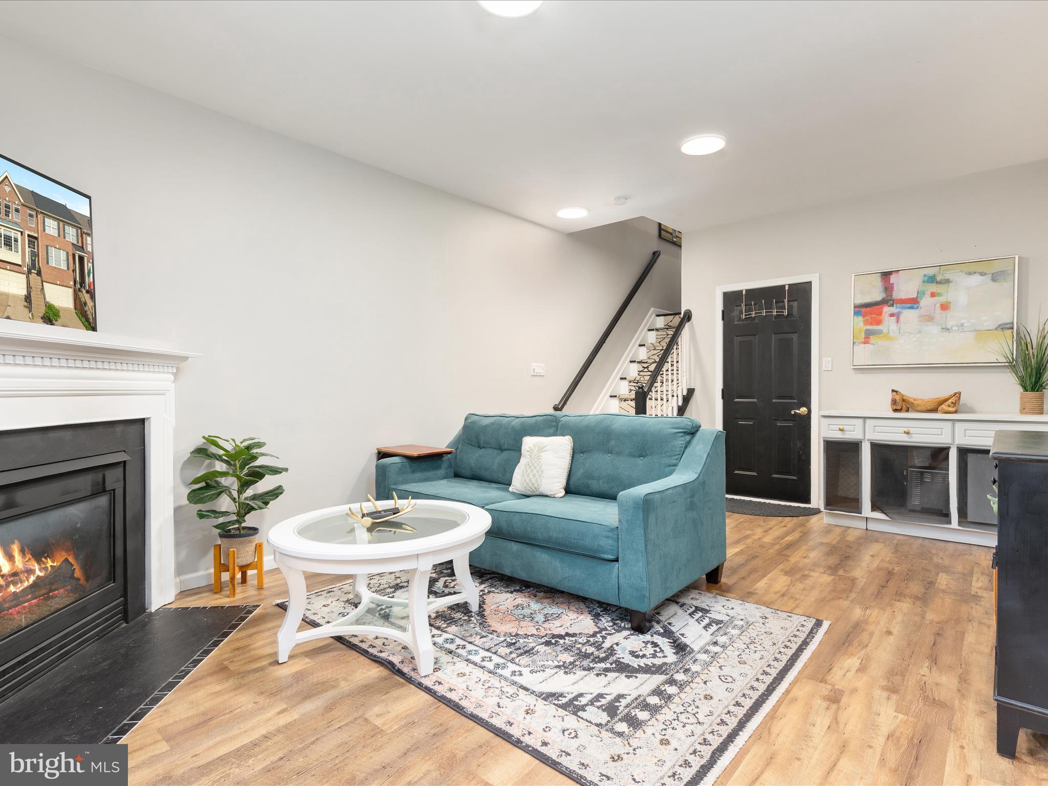 20636 Muddy Harbor Square Sterling, VA 20165 - Photo 20 of 41 a living room with furniture a fireplace and a flat screen tv