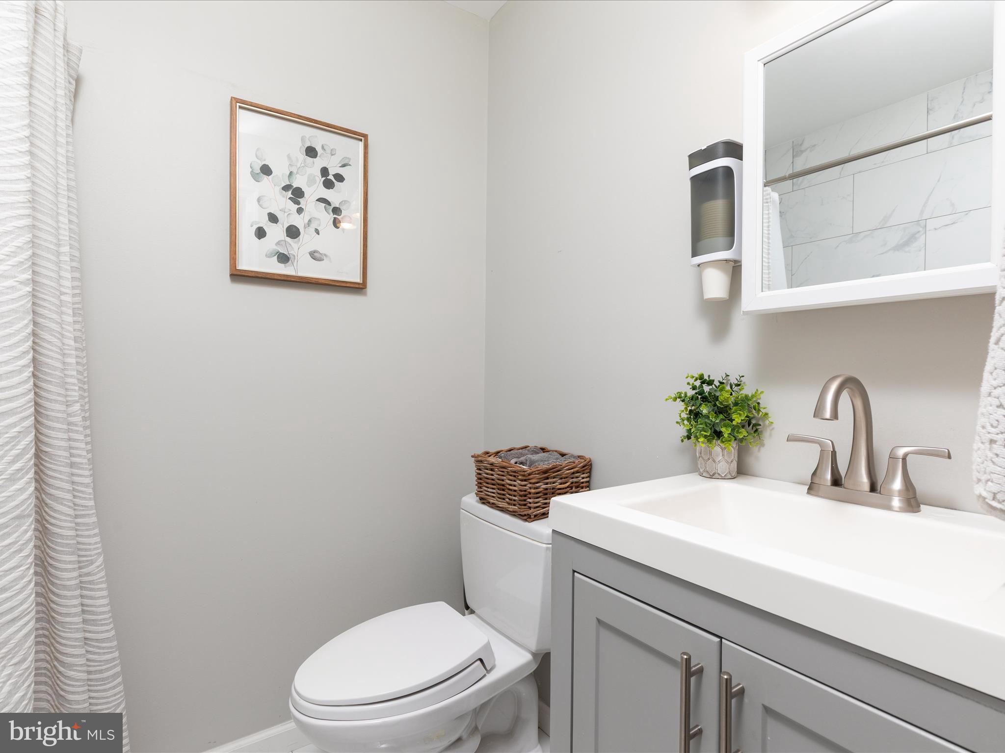 20636 Muddy Harbor Square Sterling, VA 20165 - Photo 23 of 41 a bathroom with a sink a toilet and a mirror