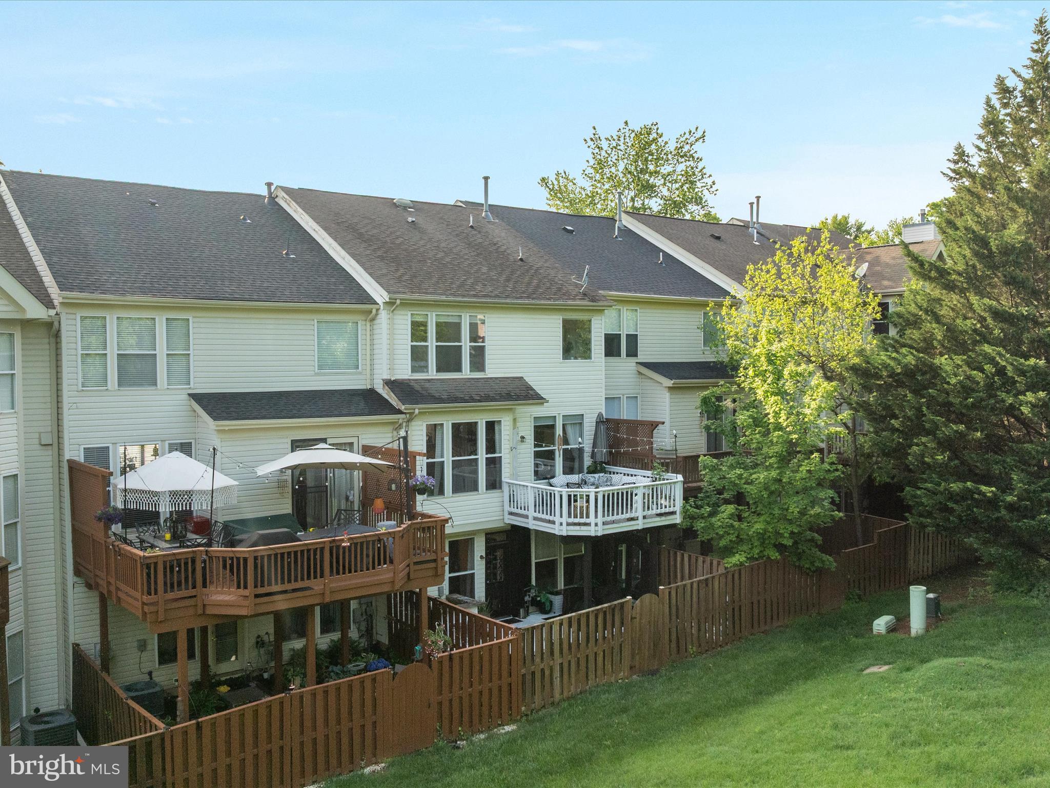 20636 Muddy Harbor Square Sterling, VA 20165 - Photo 30 of 41 a front view of a house with a yard and potted plants